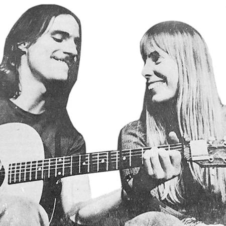 A black and white photo of James Taylor and Joni Mitchell