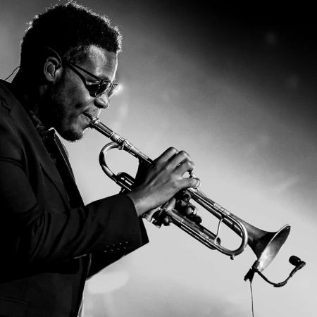 Black and white photo of Keyon Harrold playing the trumpet