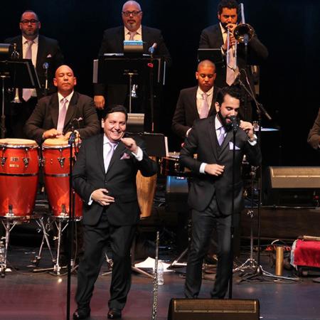 Members of Spanish Harlem Orchestra performing on stage