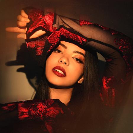 Lucía with one arm held against her forehead.